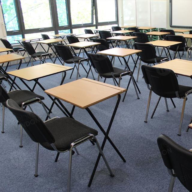 Stacking Chairs Are Great For Exams https://d1hcs5uofxldvl.cloudfront.net/online-furniture-hire/article_additional/london-school-exams10/london-school-exams10.jpg - Tables & chairs spaced properly ready for exams.